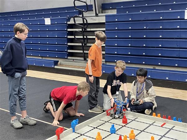 Students with a robot at a competition.